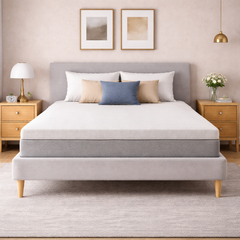 Gray upholstered bed with white mattress in a bedroom setting.